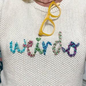 Sweater with “weirdo” hand embroidered